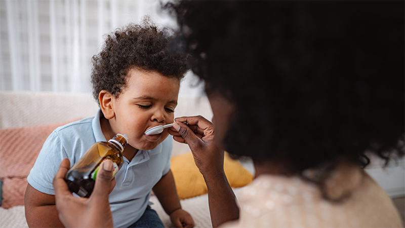 babysitter helping sick boy